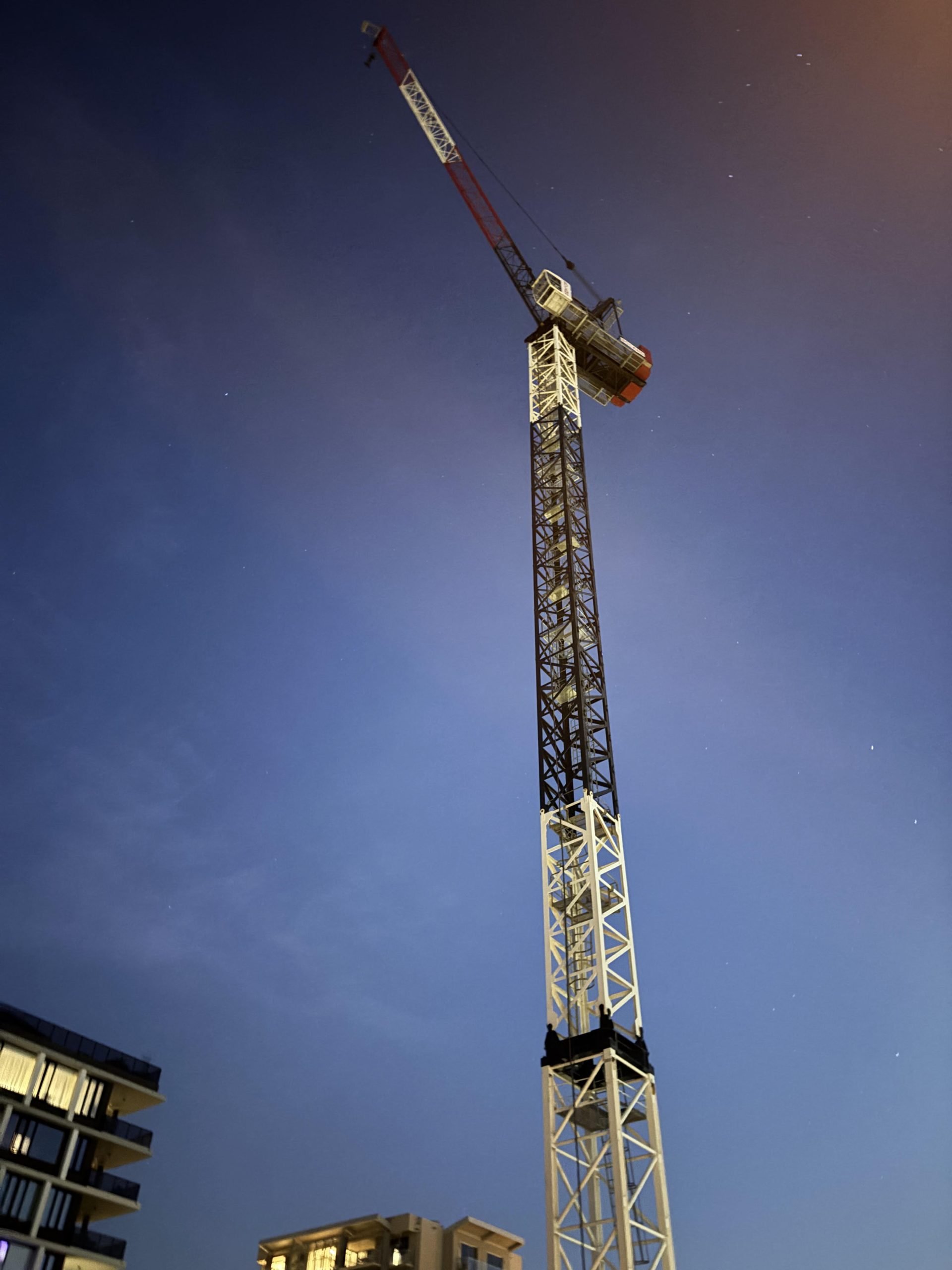 Boland Cranes Jarlway JTL160 G10 luffing tower crane photographed at night